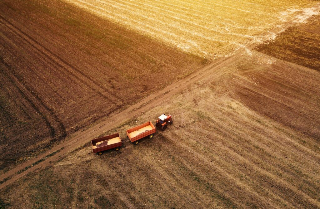 Aerial view of agricultural tractor in the field