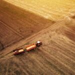 Aerial view of agricultural tractor in the field