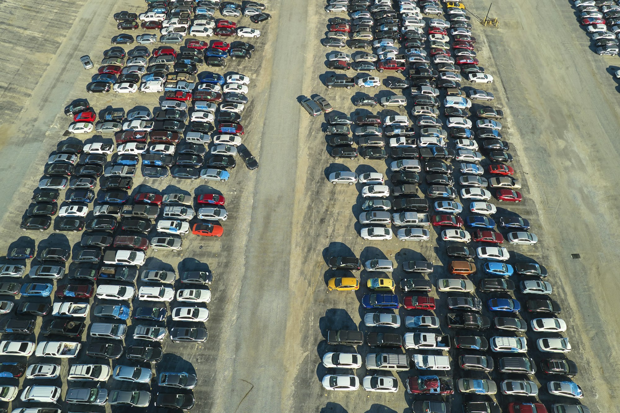 Aerial view of auction reseller company big parking lot with parked cars